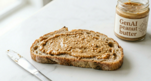 A slice of bread spread with a visible layer of peanut butter on a clean white tabletop. To the left sits a silver spreading knife, and to the right is a glass jar with a white label that reads "GenAI peanut butter".